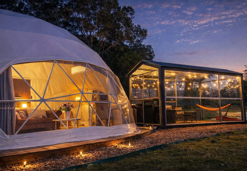The illuminated dome and its outdoor pavilion at dusk