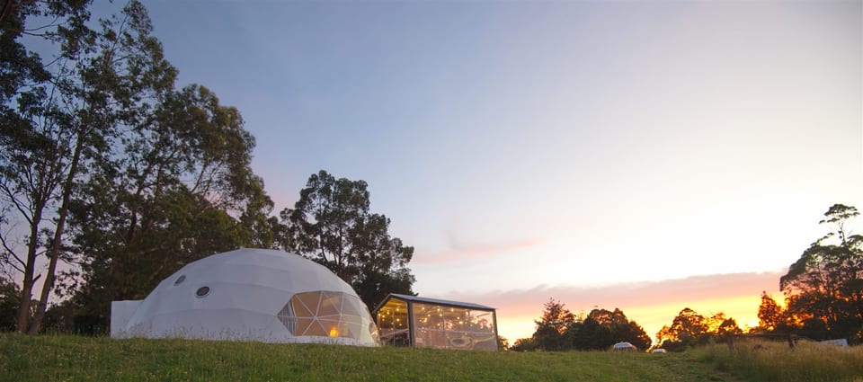 Wide view of the dome and pavilion beneath the evening sky at One Life